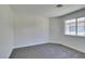 Spacious bedroom with gray carpet and large window at 7305 Backstretch Ave, Las Vegas, NV 89130