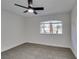 Bright bedroom featuring gray carpet and ceiling fan at 7305 Backstretch Ave, Las Vegas, NV 89130