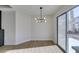 Dining area with wood-look floors and modern light fixture at 7305 Backstretch Ave, Las Vegas, NV 89130