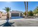 Single story home with a two car garage and desert landscaping at 7305 Backstretch Ave, Las Vegas, NV 89130