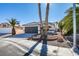 Single story home with a two car garage and desert landscaping at 7305 Backstretch Ave, Las Vegas, NV 89130