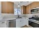 Modern kitchen with stainless steel appliances and white cabinets at 7305 Backstretch Ave, Las Vegas, NV 89130