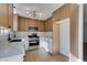 Modern kitchen featuring light wood cabinets, quartz countertops, and stainless steel appliances at 7305 Backstretch Ave, Las Vegas, NV 89130