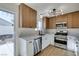 Renovated kitchen, featuring stainless steel appliances and light wood cabinets at 7305 Backstretch Ave, Las Vegas, NV 89130