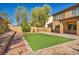 Artificial turf backyard with patio and retaining wall at 7479 Lassen Peak Cir, Las Vegas, NV 89149