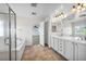 Elegant bathroom with double vanity, soaking tub, and separate shower at 7479 Lassen Peak Cir, Las Vegas, NV 89149