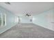 Large bedroom with carpeted floor, ceiling fan and multiple windows at 7479 Lassen Peak Cir, Las Vegas, NV 89149