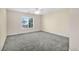 Spacious bedroom with ceiling fan and large window at 7479 Lassen Peak Cir, Las Vegas, NV 89149