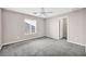 Bright bedroom with ceiling fan and large window at 7479 Lassen Peak Cir, Las Vegas, NV 89149