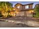 Exterior of home at night with a three-car garage at 7479 Lassen Peak Cir, Las Vegas, NV 89149