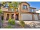 Two-story house with three-car garage and landscaped front yard at 7479 Lassen Peak Cir, Las Vegas, NV 89149