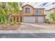 Two-story house with three-car garage and landscaped yard at 7479 Lassen Peak Cir, Las Vegas, NV 89149