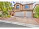 Two-story home with three car garage and landscaping at 7479 Lassen Peak Cir, Las Vegas, NV 89149