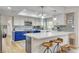 Modern kitchen with blue cabinetry, white countertops, and a breakfast bar at 7536 Spanish Bay Dr, Las Vegas, NV 89113