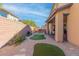 Landscaped backyard with artificial turf and patio at 7576 Windy Meadow Ave, Las Vegas, NV 89178