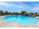 Community swimming pool with lounge chairs and pergola at 7576 Windy Meadow Ave, Las Vegas, NV 89178