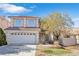 Two-story house with a two-car garage and landscaped yard at 7645 Rustic Galleon St, Las Vegas, NV 89139