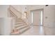 Bright entryway with tiled floors and a carpeted staircase at 8236 Horseshoe Bend Ln, Las Vegas, NV 89113