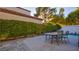 Stone patio with table and chairs near the pool at 8236 Horseshoe Bend Ln, Las Vegas, NV 89113