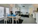 Open dining area with modern table and chairs near living room at 8808 Tom Noon Ave # 101, Las Vegas, NV 89178