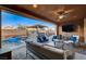 Relaxing backyard patio with seating area, TV, and ceiling fan at 8970 Rancho Durango Ct, Las Vegas, NV 89148