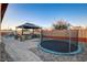 Large backyard with a trampoline and outdoor kitchen at 8970 Rancho Durango Ct, Las Vegas, NV 89148