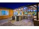 Outdoor kitchen with grill and stone, at night at 8970 Rancho Durango Ct, Las Vegas, NV 89148