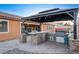 Outdoor kitchen with a grill and stone countertops at 8970 Rancho Durango Ct, Las Vegas, NV 89148