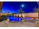 Night view of the pool with waterfall and spa at 8970 Rancho Durango Ct, Las Vegas, NV 89148