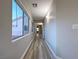 Light-filled hallway with wood-look floors and large windows at 8971 Dallas Ridge Ave, Las Vegas, NV 89178