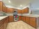 L-shaped kitchen with wood cabinets and stainless steel appliances at 8971 Dallas Ridge Ave, Las Vegas, NV 89178