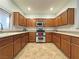 L-shaped kitchen with wood cabinets and stainless steel appliances at 8971 Dallas Ridge Ave, Las Vegas, NV 89178