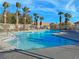 Inviting community pool with palm trees and ample deck space at 8971 Dallas Ridge Ave, Las Vegas, NV 89178