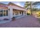 Backyard patio with covered seating area and golf course view at 9520 Sundial Dr, Las Vegas, NV 89134