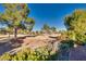 Landscaped backyard with golf course view and mountain backdrop at 9520 Sundial Dr, Las Vegas, NV 89134