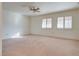 Spacious bedroom with ceiling fan, plantation shutters, and carpeted floors at 9520 Sundial Dr, Las Vegas, NV 89134