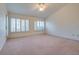 Spacious bedroom with plush carpeting and large windows with plantation shutters at 9520 Sundial Dr, Las Vegas, NV 89134