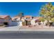 Single-story house with tile roof, attached garage, and landscaped yard at 9520 Sundial Dr, Las Vegas, NV 89134