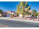 Single-story house with tile roof, attached garage, and mature trees at 9520 Sundial Dr, Las Vegas, NV 89134