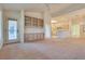 Spacious living area with built-in shelving and access to a patio at 9520 Sundial Dr, Las Vegas, NV 89134