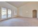 Spacious living room with high ceilings, carpet, and double doors at 9520 Sundial Dr, Las Vegas, NV 89134