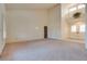 Bright living room with high ceilings, carpet, and double doors at 9520 Sundial Dr, Las Vegas, NV 89134