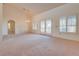 Open living room with high ceilings, chandelier, and French doors at 9520 Sundial Dr, Las Vegas, NV 89134