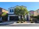 Two-story house with dark brown garage door and landscaped front yard at 9545 Belmont Bay Ave, Las Vegas, NV 89148