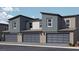 Three-unit townhome building, featuring attached garages and desert landscaping at , North Las Vegas, NV 89084