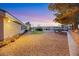 Landscaped backyard with gravel and lighting at 10032 Fox Springs Dr, Las Vegas, NV 89117