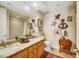 Elegant bathroom with double vanity, granite countertops, and decorative accents at 10032 Fox Springs Dr, Las Vegas, NV 89117