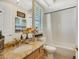 Clean bathroom with single vanity, shower/tub combo, and light color tile at 10032 Fox Springs Dr, Las Vegas, NV 89117