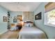 Cozy bedroom with a queen bed, built-in shelves, and window seat at 10032 Fox Springs Dr, Las Vegas, NV 89117