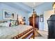 Well-lit bedroom with wooden post bed and sunflower decor at 10032 Fox Springs Dr, Las Vegas, NV 89117
